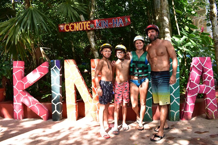 Family at the Kin-Ha sign on Ruta de los Cenotes