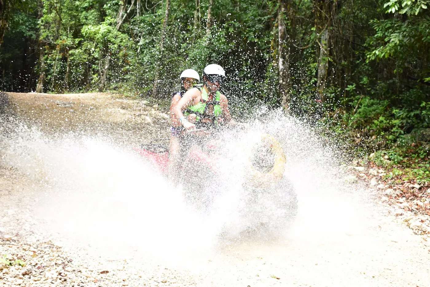 ATV riders splashing through the Kin-Ha jungle route near Puerto Morelos