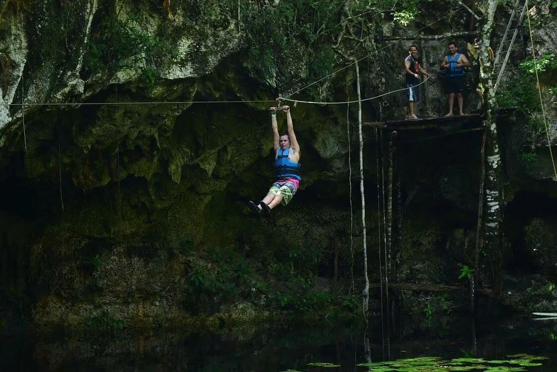 Zipline over cenote water on the Kin-Ha jungle route